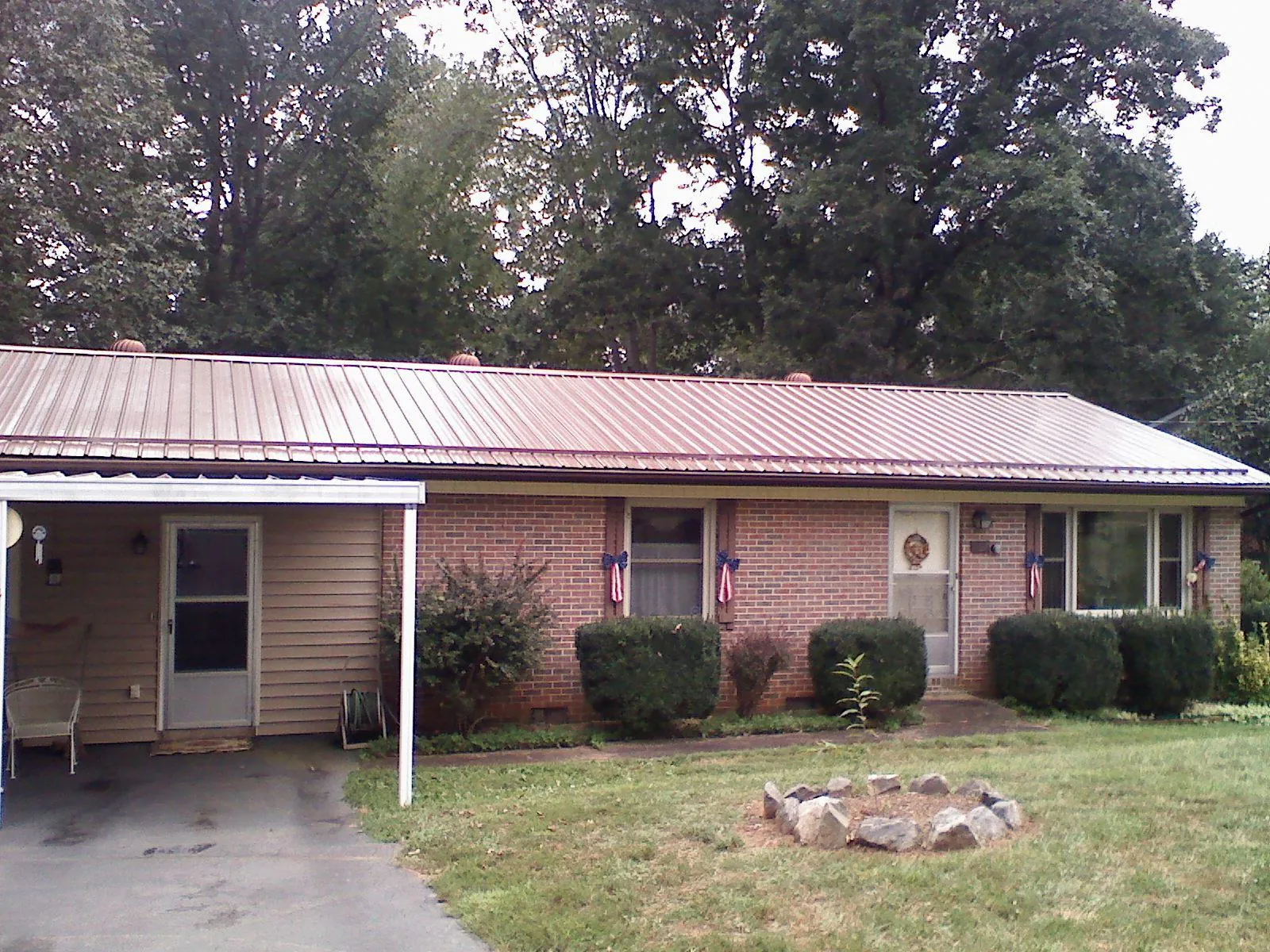 Bronze metal roof and carport on a brick ranch home — Roof Repair work by our crew in Boonville